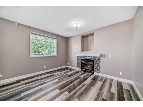 27 Canoe Circle Sw, Airdrie, AB - Indoor Photo Showing Other Room With Fireplace