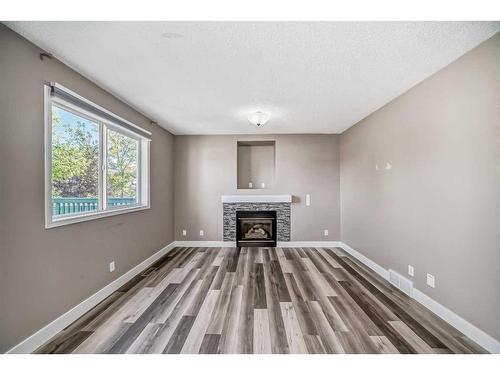 27 Canoe Circle Sw, Airdrie, AB - Indoor Photo Showing Other Room With Fireplace