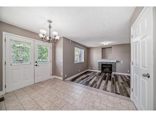 27 Canoe Circle Sw, Airdrie, AB - Indoor Photo Showing Other Room With Fireplace