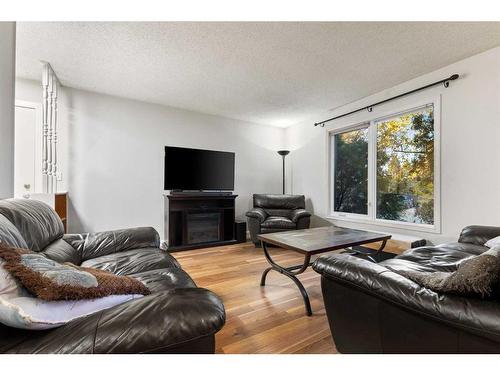 11 Midbend Crescent Se, Calgary, AB - Indoor Photo Showing Living Room With Fireplace