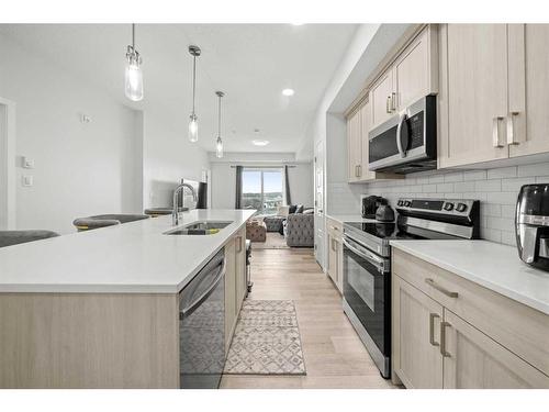 411-40 Carrington Plaza Nw, Calgary, AB - Indoor Photo Showing Kitchen With Stainless Steel Kitchen With Double Sink With Upgraded Kitchen