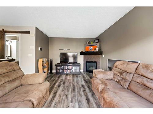 4-29 Poplar Avenue, Okotoks, AB - Indoor Photo Showing Living Room With Fireplace