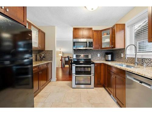 53 Shawinigan Road Sw, Calgary, AB - Indoor Photo Showing Kitchen With Double Sink