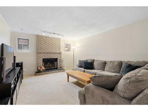 53 Shawinigan Road Sw, Calgary, AB - Indoor Photo Showing Living Room With Fireplace