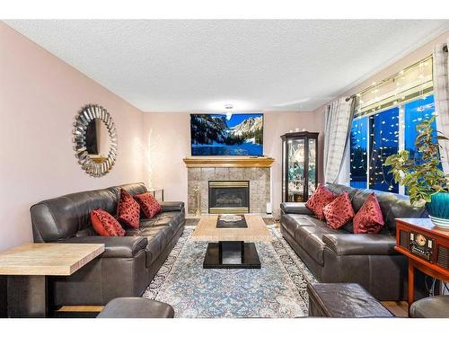 9838 Hidden Valley Drive Nw, Calgary, AB - Indoor Photo Showing Living Room With Fireplace