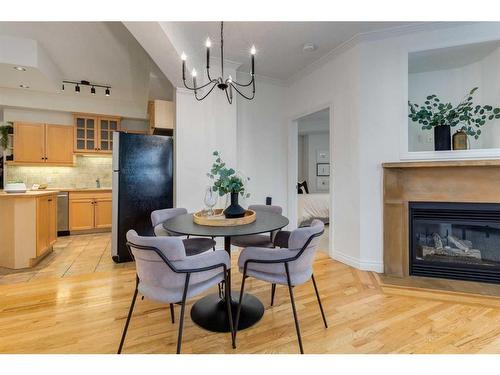 201-1315 12 Avenue Sw, Calgary, AB - Indoor Photo Showing Dining Room With Fireplace