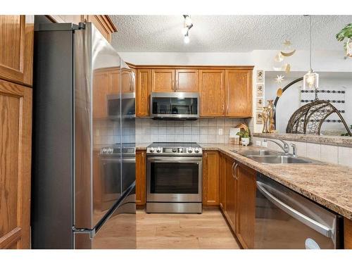 305-390 Marina Drive, Chestermere, AB - Indoor Photo Showing Kitchen With Double Sink