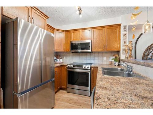 305-390 Marina Drive, Chestermere, AB - Indoor Photo Showing Kitchen With Double Sink