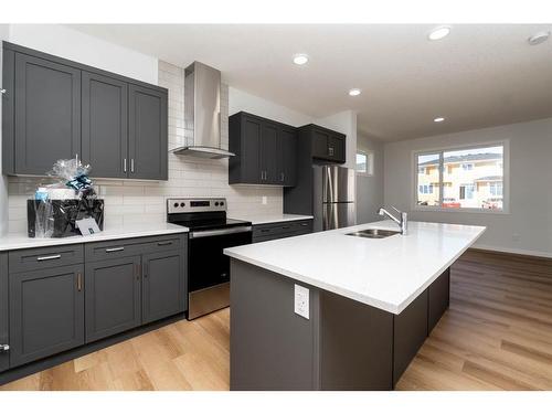 140 Langwell Common Se, Airdrie, AB - Indoor Photo Showing Kitchen With Double Sink With Upgraded Kitchen