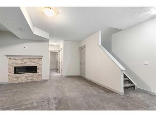 65 River Heights Drive, Cochrane, AB - Indoor With Fireplace