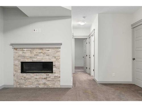 65 River Heights Drive, Cochrane, AB - Indoor Photo Showing Living Room With Fireplace