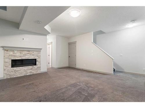 65 River Heights Drive, Cochrane, AB - Indoor Photo Showing Other Room With Fireplace