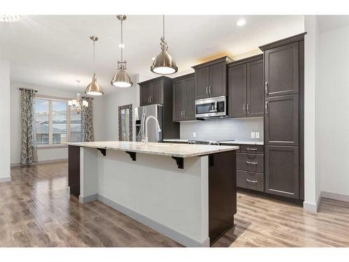 65 River Heights Drive, Cochrane, AB - Indoor Photo Showing Kitchen With Upgraded Kitchen