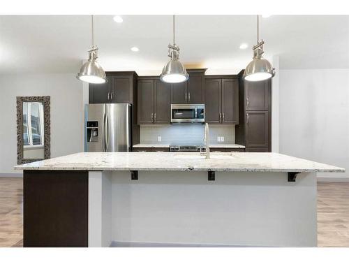 65 River Heights Drive, Cochrane, AB - Indoor Photo Showing Kitchen With Upgraded Kitchen