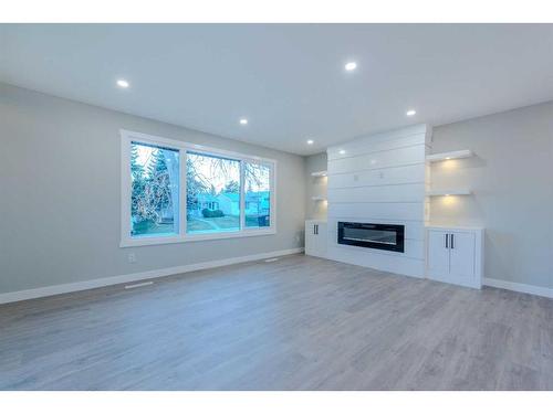 7447 Huntertown Crescent Nw, Calgary, AB - Indoor Photo Showing Living Room With Fireplace