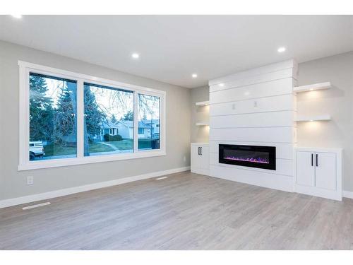 7447 Huntertown Crescent Nw, Calgary, AB - Indoor Photo Showing Living Room With Fireplace