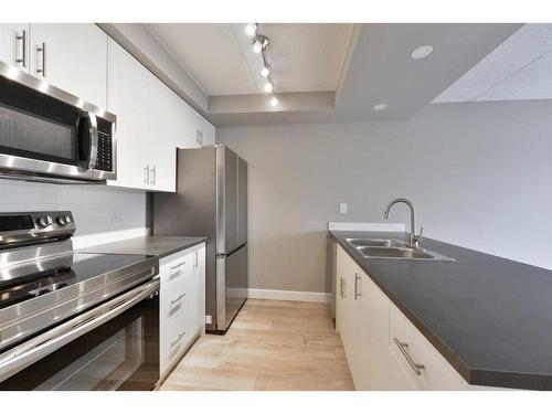 605-2200 Woodview Drive Sw, Calgary, AB - Indoor Photo Showing Kitchen With Double Sink