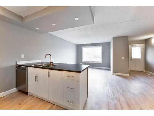 605-2200 Woodview Drive Sw, Calgary, AB - Indoor Photo Showing Kitchen With Double Sink