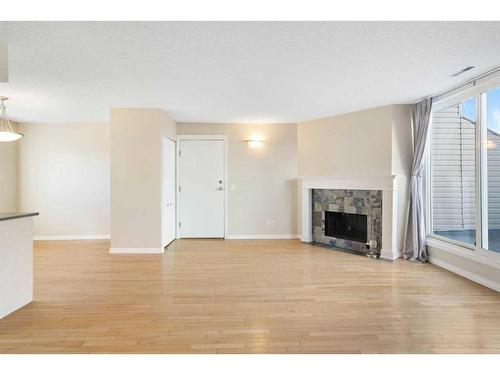 803-1540 29 Street Nw, Calgary, AB - Indoor Photo Showing Living Room With Fireplace