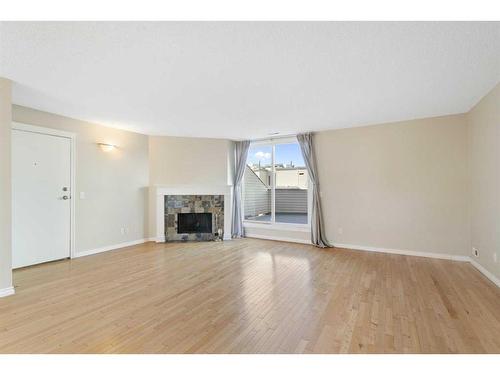 803-1540 29 Street Nw, Calgary, AB - Indoor Photo Showing Living Room With Fireplace