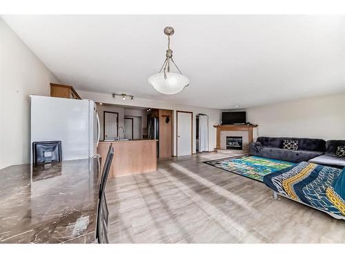 25 Taracove Way Ne, Calgary, AB - Indoor With Fireplace