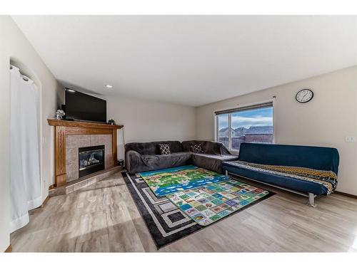 25 Taracove Way Ne, Calgary, AB - Indoor Photo Showing Living Room With Fireplace