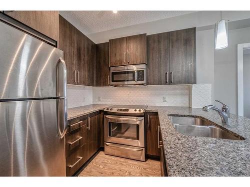 304-8 Sage Hill Terrace Nw, Calgary, AB - Indoor Photo Showing Kitchen With Stainless Steel Kitchen With Double Sink With Upgraded Kitchen