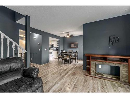 66 Everglade Drive Se, Airdrie, AB - Indoor Photo Showing Living Room With Fireplace