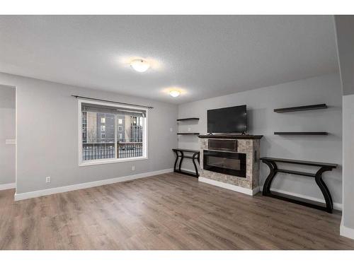 74 Canals Circle Sw, Airdrie, AB - Indoor Photo Showing Living Room With Fireplace