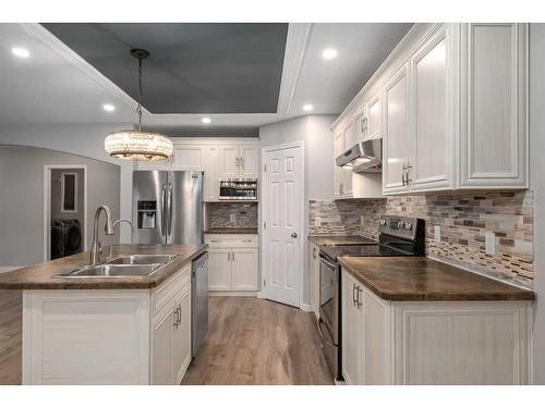 74 Canals Circle Sw, Airdrie, AB - Indoor Photo Showing Kitchen With Double Sink With Upgraded Kitchen