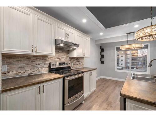 74 Canals Circle Sw, Airdrie, AB - Indoor Photo Showing Kitchen With Double Sink With Upgraded Kitchen