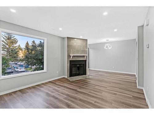 13-2519 38 Street Ne, Calgary, AB - Indoor Photo Showing Living Room With Fireplace