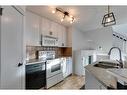 45 Prestwick Avenue Se, Calgary, AB  - Indoor Photo Showing Kitchen With Double Sink 