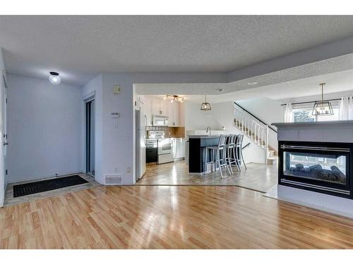 45 Prestwick Avenue Se, Calgary, AB - Indoor Photo Showing Living Room With Fireplace