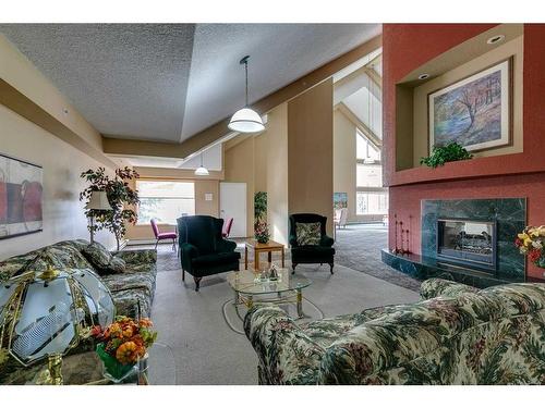 245-6868 Sierra Morena Boulevard Sw, Calgary, AB - Indoor Photo Showing Living Room With Fireplace