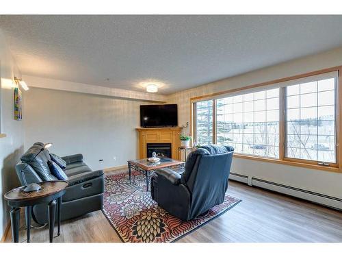 245-6868 Sierra Morena Boulevard Sw, Calgary, AB - Indoor Photo Showing Living Room With Fireplace