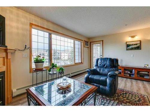 245-6868 Sierra Morena Boulevard Sw, Calgary, AB - Indoor Photo Showing Living Room With Fireplace