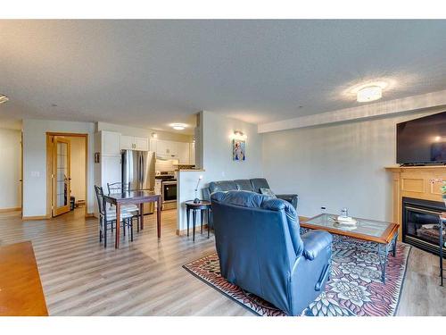 245-6868 Sierra Morena Boulevard Sw, Calgary, AB - Indoor Photo Showing Living Room With Fireplace