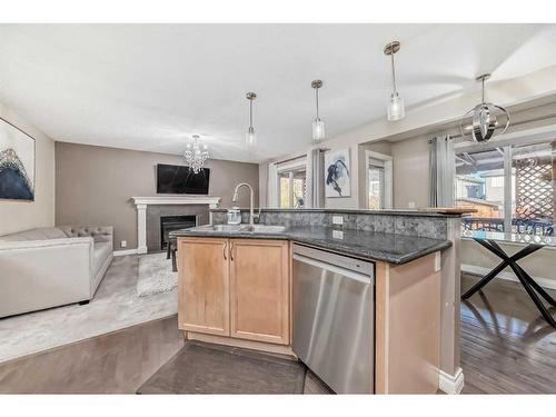 257 Bridlemeadows Common Sw, Calgary, AB - Indoor Photo Showing Kitchen With Fireplace