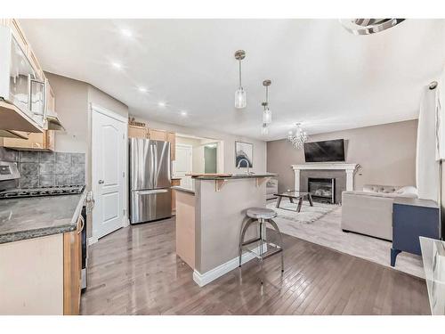 257 Bridlemeadows Common Sw, Calgary, AB - Indoor Photo Showing Kitchen With Fireplace With Stainless Steel Kitchen With Upgraded Kitchen