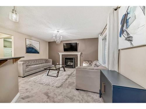 257 Bridlemeadows Common Sw, Calgary, AB - Indoor Photo Showing Living Room With Fireplace