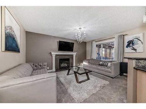 257 Bridlemeadows Common Sw, Calgary, AB - Indoor Photo Showing Living Room With Fireplace