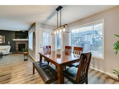 15 Cranfield Crescent Se, Calgary, AB - Indoor Photo Showing Dining Room With Fireplace