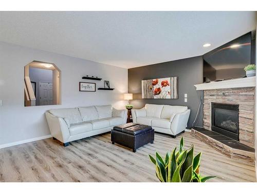 15 Cranfield Crescent Se, Calgary, AB - Indoor Photo Showing Living Room With Fireplace