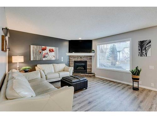 15 Cranfield Crescent Se, Calgary, AB - Indoor Photo Showing Living Room With Fireplace