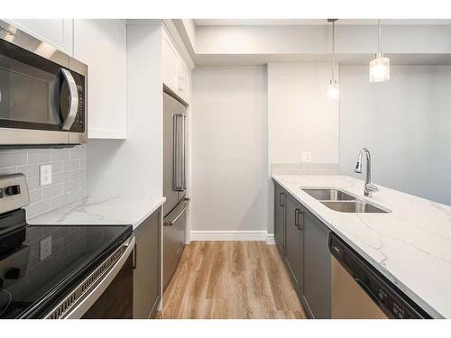 302-19661 40 Street Se, Calgary, AB - Indoor Photo Showing Kitchen With Stainless Steel Kitchen With Double Sink With Upgraded Kitchen