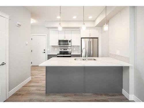 302-19661 40 Street Se, Calgary, AB - Indoor Photo Showing Kitchen With Stainless Steel Kitchen With Double Sink With Upgraded Kitchen