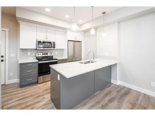 302-19661 40 Street Se, Calgary, AB - Indoor Photo Showing Kitchen With Stainless Steel Kitchen With Double Sink With Upgraded Kitchen