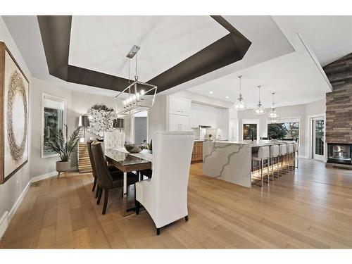 27 Meadow Pointe Drive, Heritage Pointe, AB - Indoor Photo Showing Dining Room With Fireplace