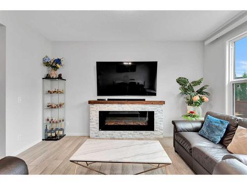 12 Rowley Terrace Nw, Calgary, AB - Indoor Photo Showing Living Room With Fireplace